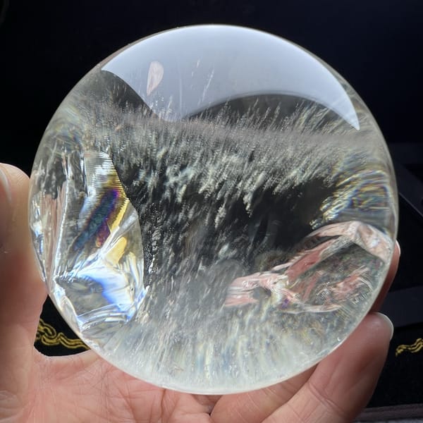 Fringe of white grass-like inclusions along a plane inside the sphere