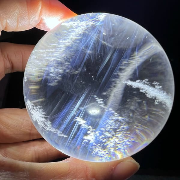 Torch-lit clear sphere with long blue needles and white snow clouds