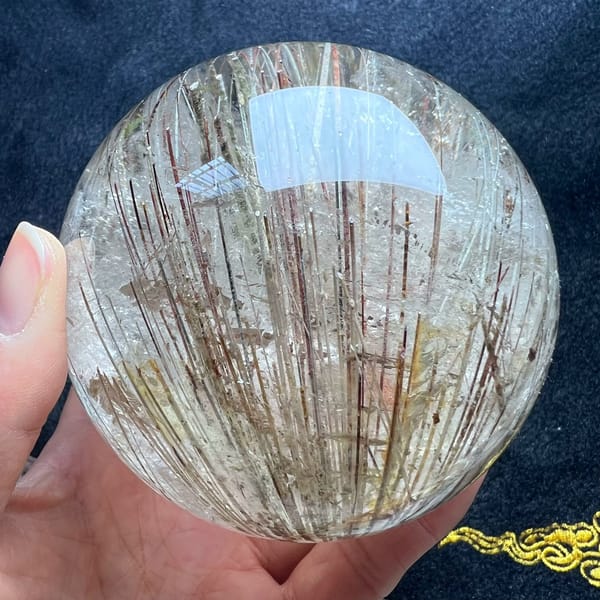 Sheaf of parallel rutile needles filling the clear quartz sphere