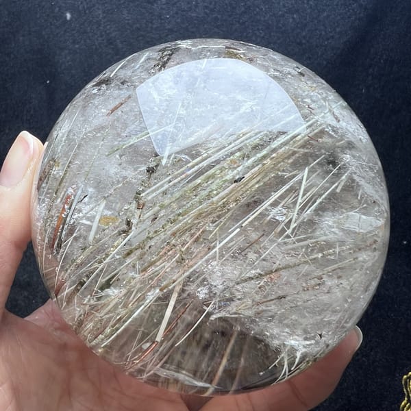 Diagonal rutile needles in silvery tones across the far side