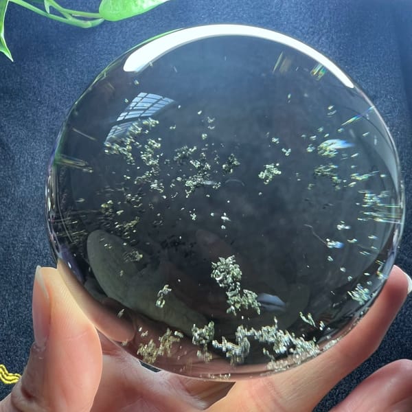 Starry drift of green phantom flecks across the middle of the sphere