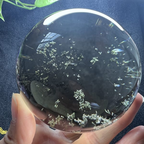 Dense band of green flecks across the lower half of the sphere