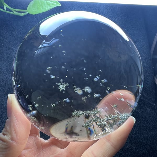 Small clusters of green flecks low in the transparent sphere