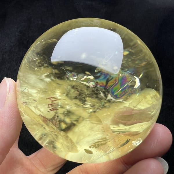 Faint rainbow beneath the reflection with yellow veils around it