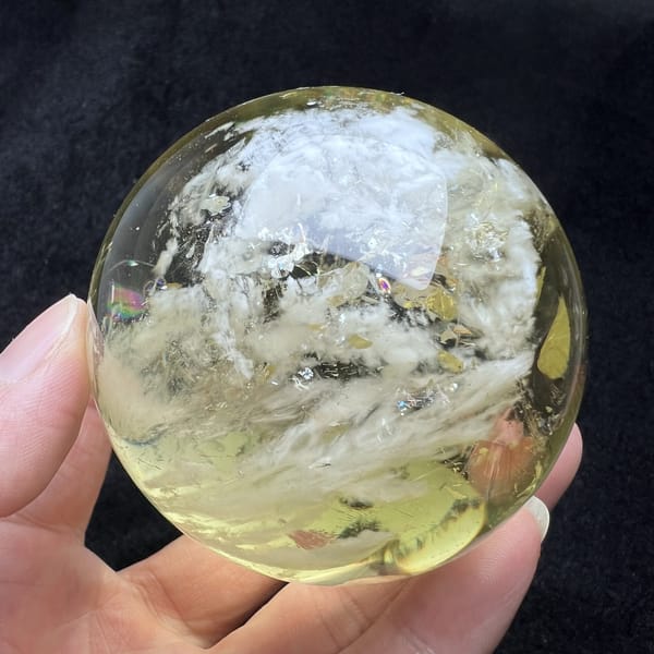 White cloud inclusion spreading through the upper half of the sphere