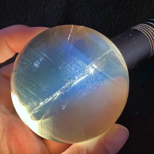 Blue fog and fine needles lit by a torch beside the sphere