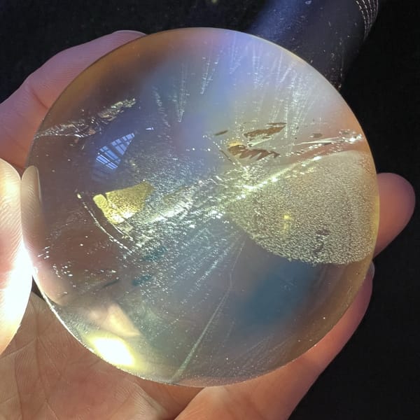 Golden flakes and a white misty veil seen under side light