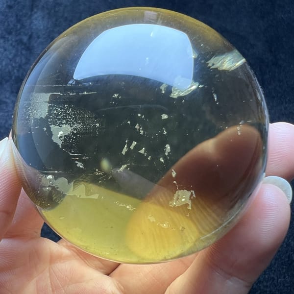 Golden flakes floating in clear yellow quartz near the edge