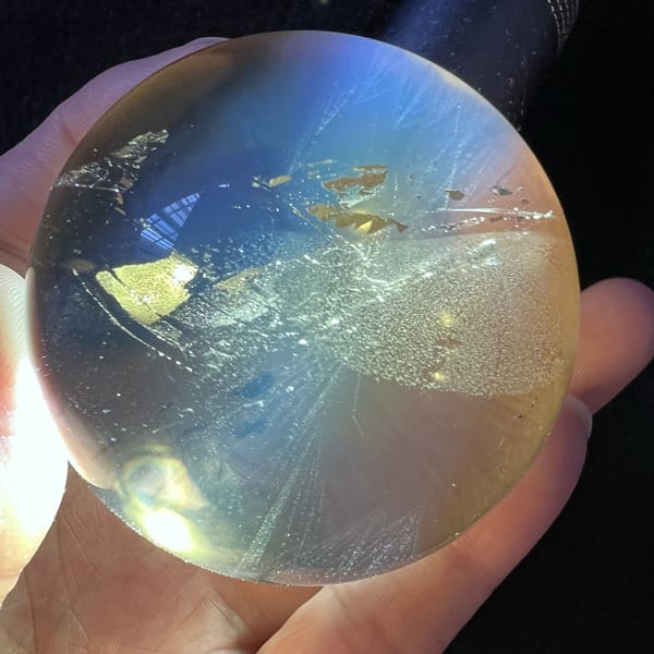 White veil and gold flakes lit from the left inside the citrine