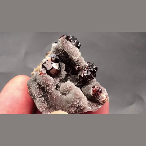 Dark Red Sphalerite Crystals on a Pale Quartz Peak - complete view