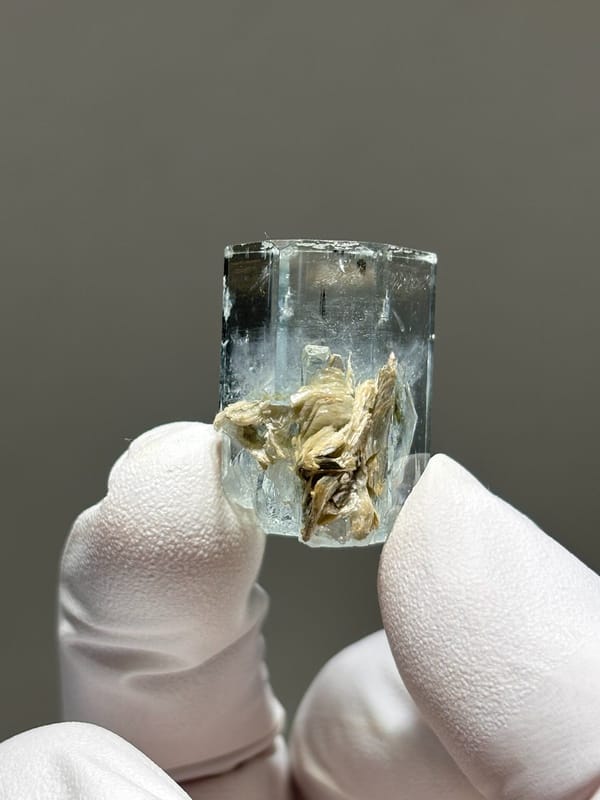 Gem aquamarine with mica grown half inside it from Pakistan, second angle
