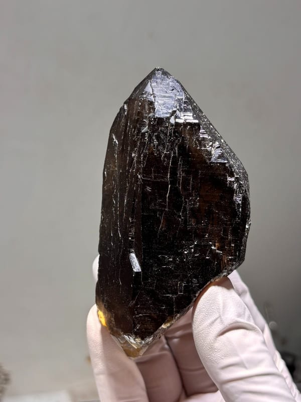 Dark smoky quartz floater from Fujian, China, detail of the matrix contact