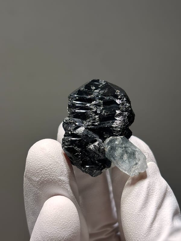 Pale aquamarine on black cassiterite from Xuebaoding, Sichuan, China, reverse side