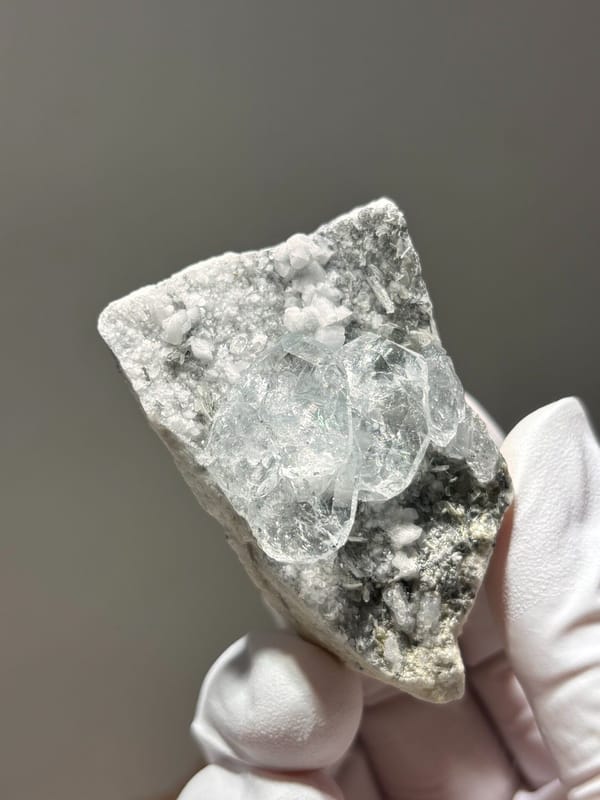 Heart-shaped aquamarine on white feldspar from Xuebaoding, Sichuan, China, reverse side