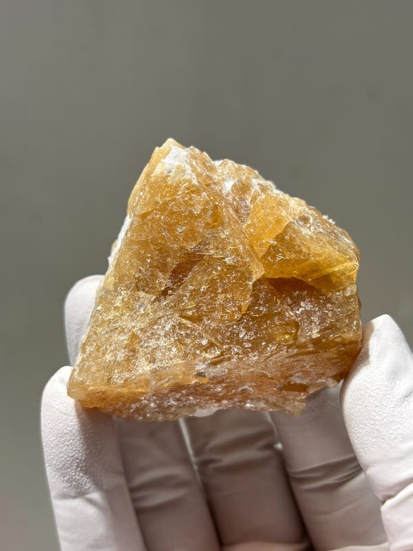 Honey-orange scheelite crystal from Xuebaoding, Sichuan, China, close-up of the crystal faces