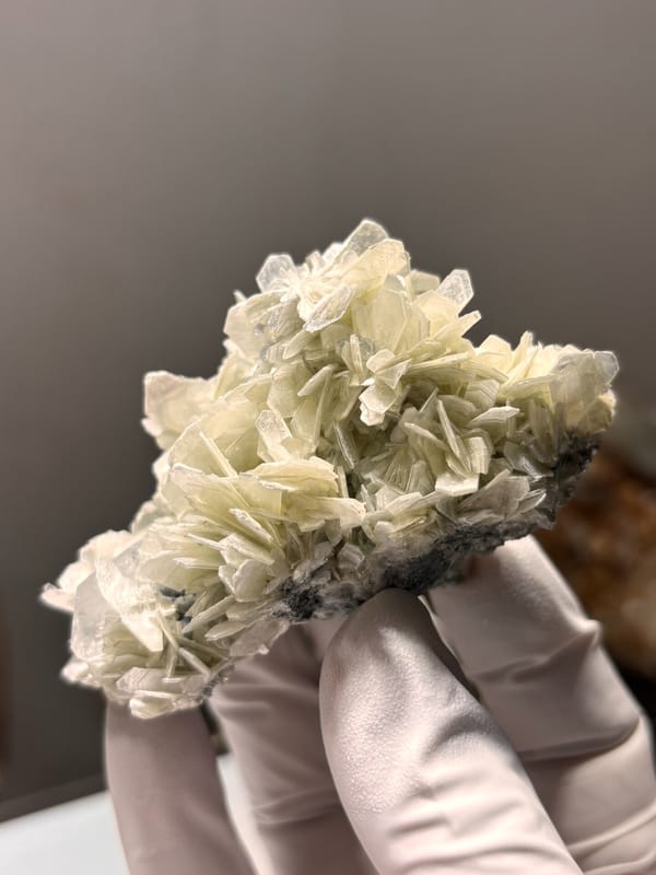 Cluster of pale mica rosettes with aquamarine from Xuebaoding, Sichuan, China, second angle