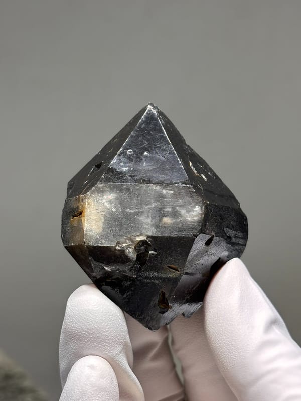Stout jet-black double-terminated quartz from Guizhou, China, close-up of the crystal faces