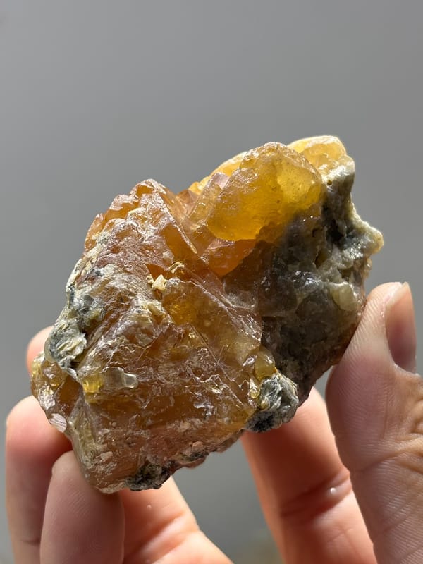 Large honey-orange scheelite crystal from Xuebaoding, Sichuan, China, close-up of the crystal faces