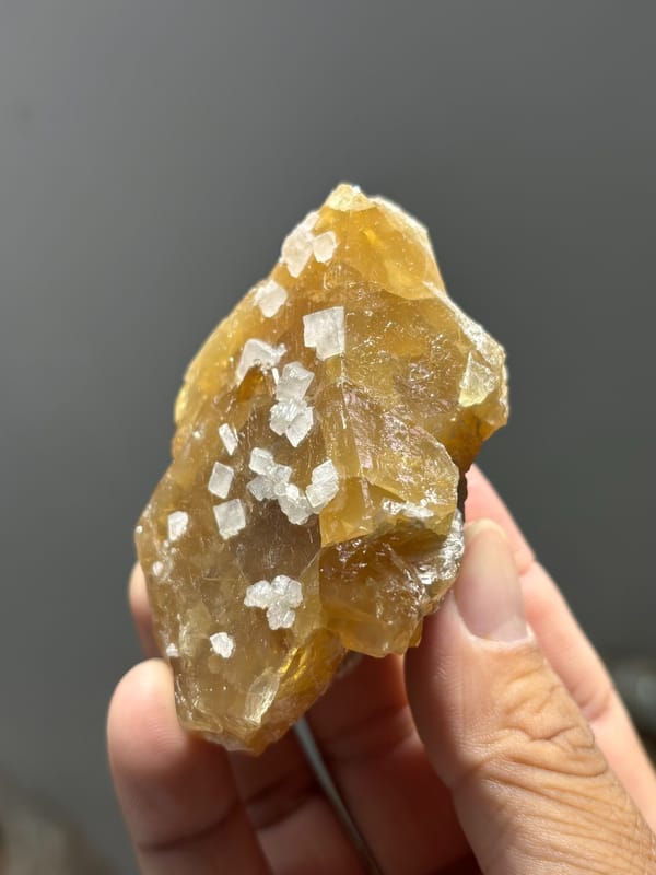 Honey scheelite dotted with white calcite crystals from Xuebaoding, Sichuan, China, second angle