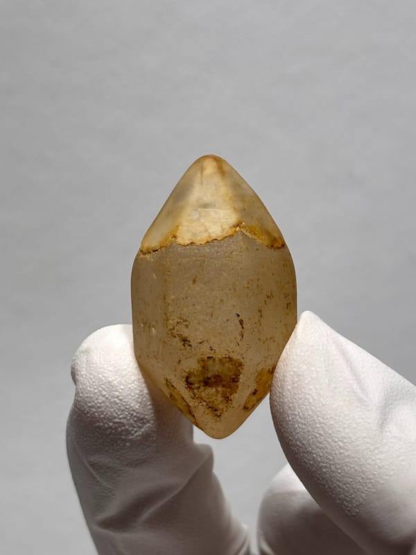 Six-window water-worn quartz with white cap from Yunnan, China, close-up of the crystal faces
