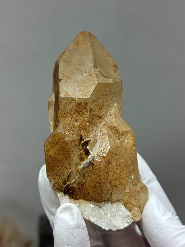 Golden quartz point with sculpted form from Xuebaoding, Sichuan, China, close-up of the crystal faces