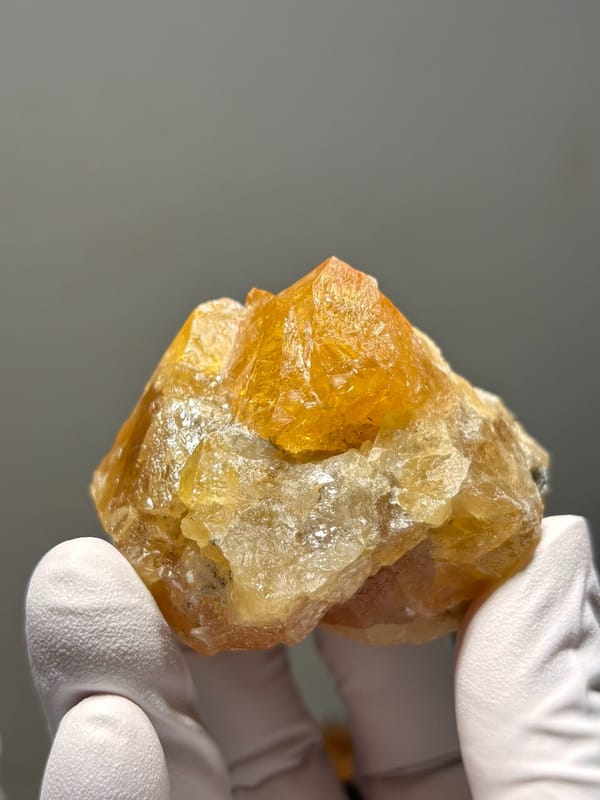 Orange scheelite crystal group from Xuebaoding, Sichuan, China, close-up of the crystal faces