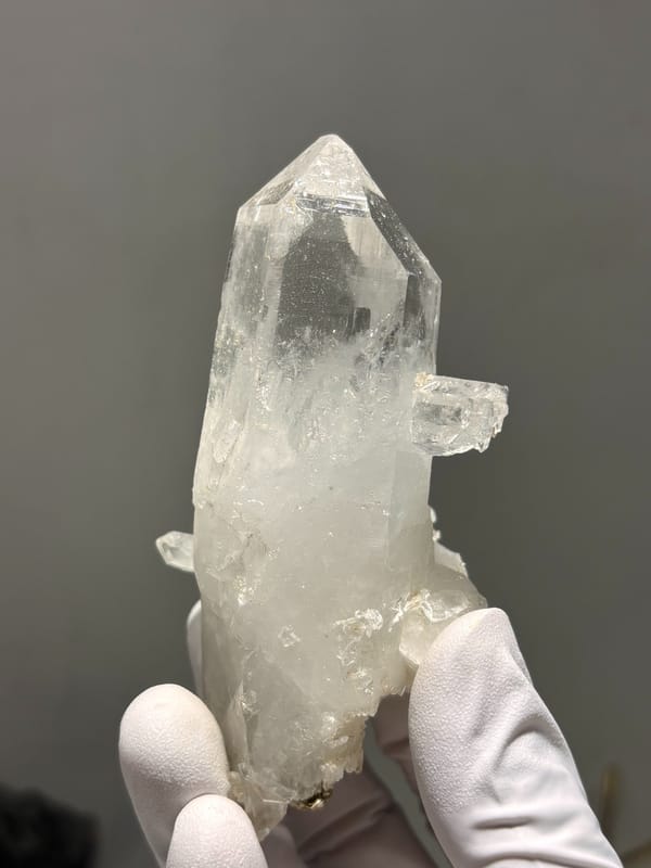Clear quartz point on white cluster from Xuebaoding, Sichuan, China, second angle
