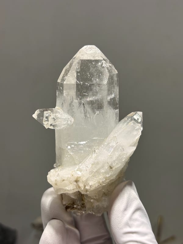 Clear quartz point on white cluster from Xuebaoding, Sichuan, China, close-up of the crystal faces