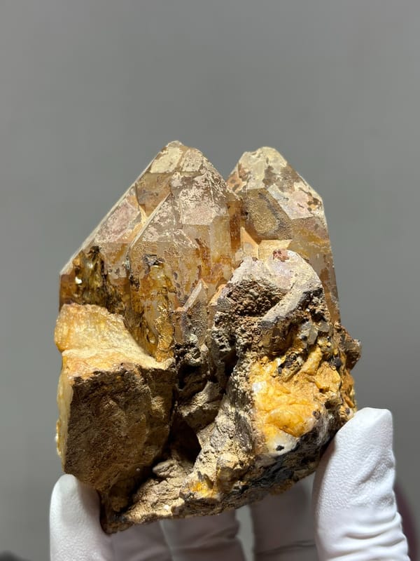 Tan cathedral quartz cluster on golden matrix from Xuebaoding, Sichuan, China