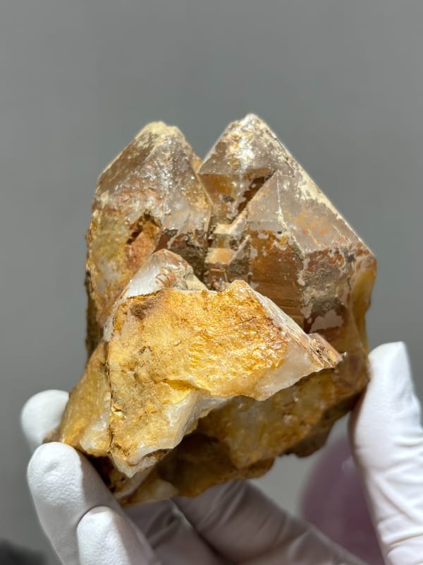 Tan cathedral quartz cluster on golden matrix from Xuebaoding, Sichuan, China, reverse side