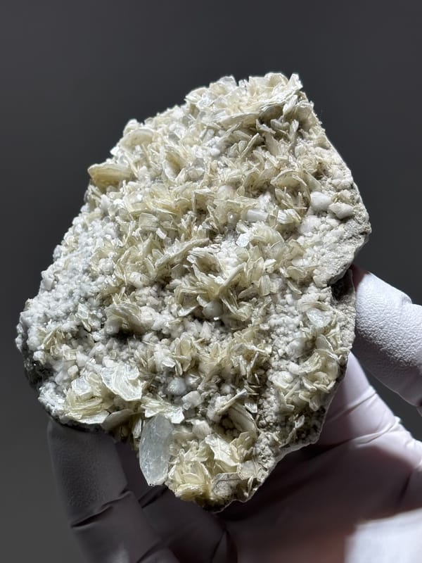 Pale mica plate with small aquamarine crystal from Xuebaoding, Sichuan, China, second angle