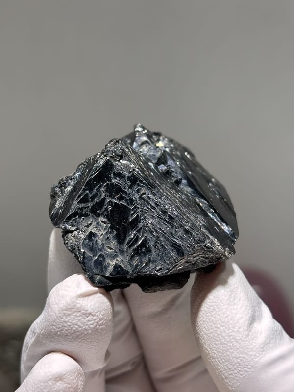 Large glossy black cassiterite crystal from Xuebaoding, Sichuan, China, second angle