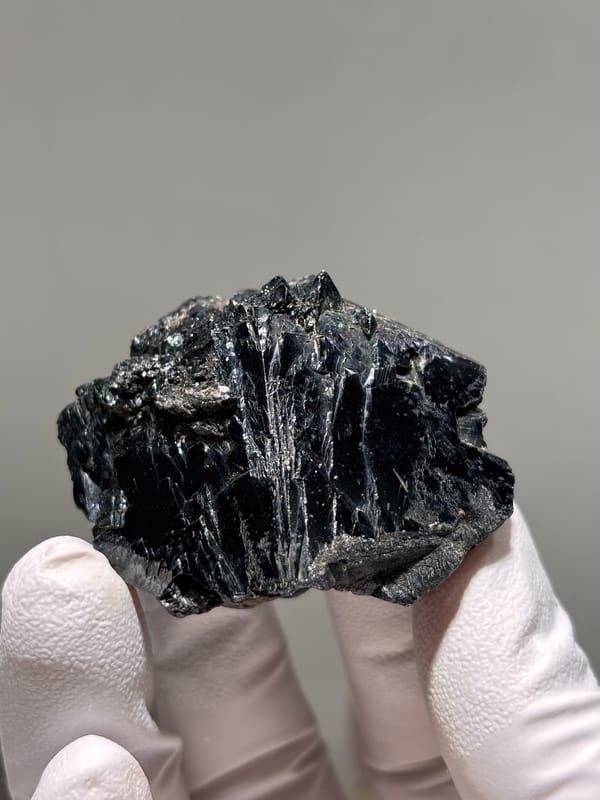 Large glossy black cassiterite crystal from Xuebaoding, Sichuan, China, close-up of the crystal faces