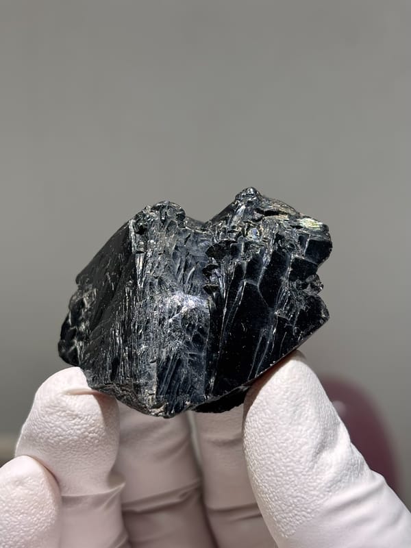 Large glossy black cassiterite crystal from Xuebaoding, Sichuan, China, reverse side