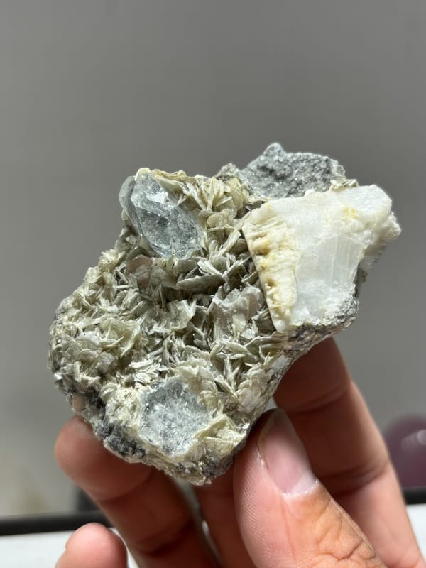 Mica plate with aquamarine on both faces and feldspar from Xuebaoding, Sichuan, China, close-up of the crystal faces