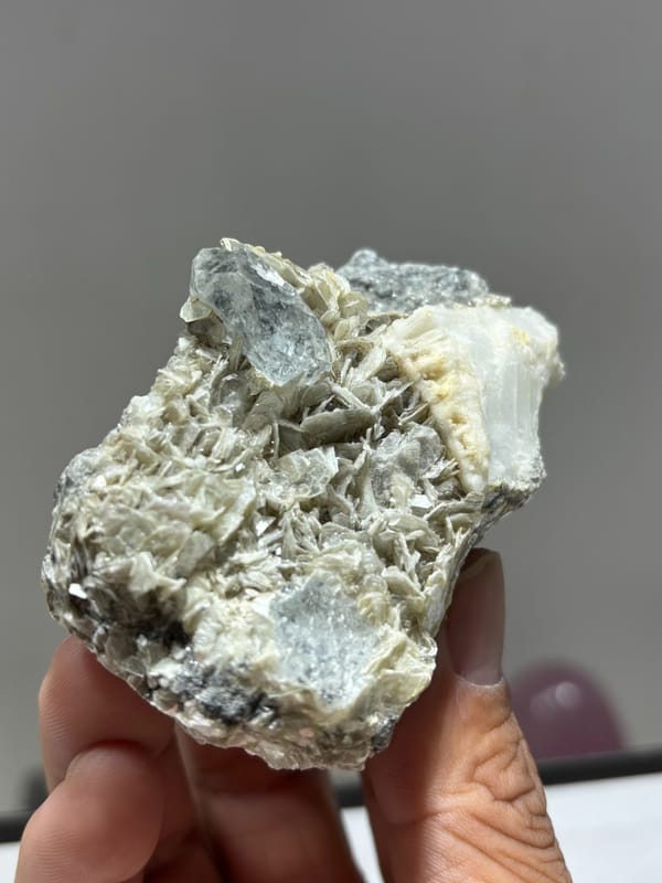 Mica plate with aquamarine on both faces and feldspar from Xuebaoding, Sichuan, China, reverse side