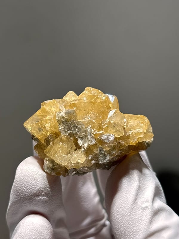 Golden scheelite cluster of intergrown crystals from Xuebaoding, Sichuan, China, reverse side
