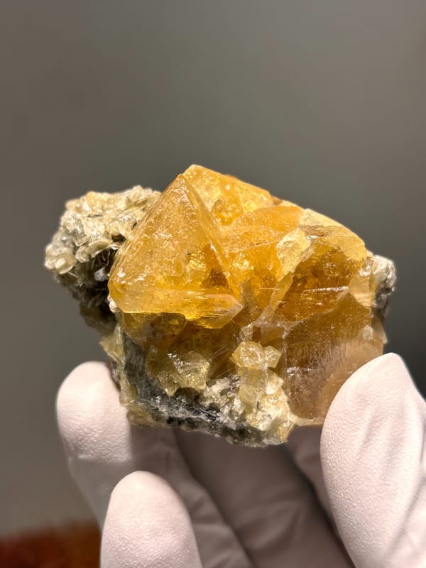 Golden scheelite cluster with mica from Xuebaoding, Sichuan, China, second angle