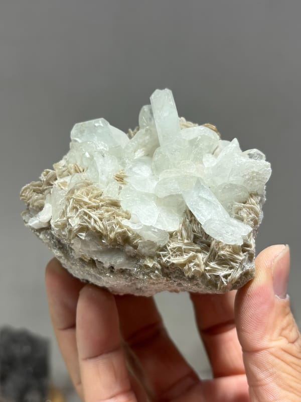 Pale aquamarine cluster on tan mica from Xuebaoding, Sichuan, China, second angle