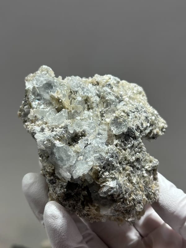 Grey mica block with many small aquamarine crystals from Xuebaoding, Sichuan, China, second angle