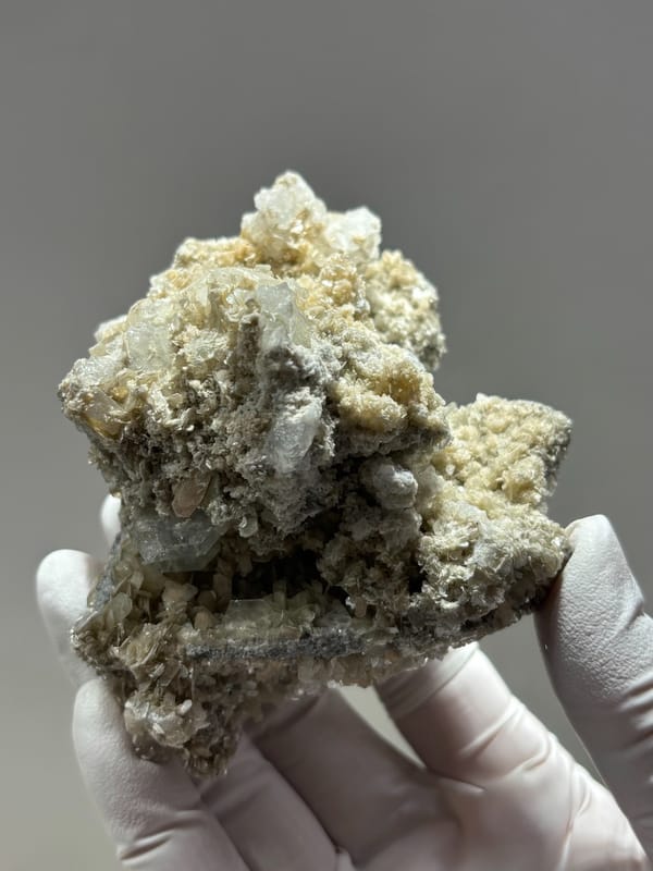 Grey mica block with many small aquamarine crystals from Xuebaoding, Sichuan, China, close-up of the crystal faces