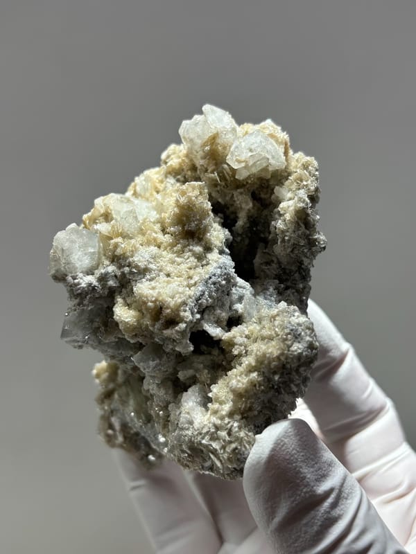 Grey mica block with many small aquamarine crystals from Xuebaoding, Sichuan, China, reverse side