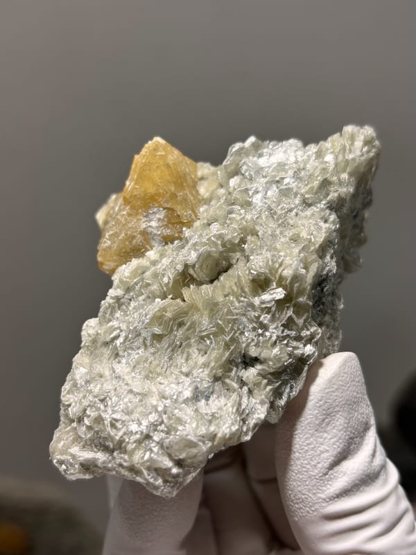 Honey scheelite on silvery mica plate from Xuebaoding, Sichuan, China, reverse side