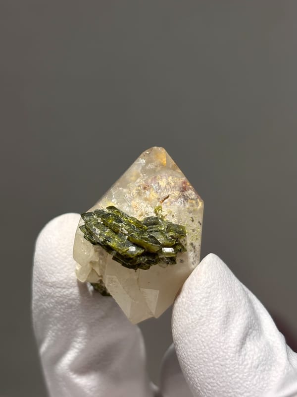 Double-terminated garden quartz with epidote cluster from Sichuan, China, detail of the matrix contact