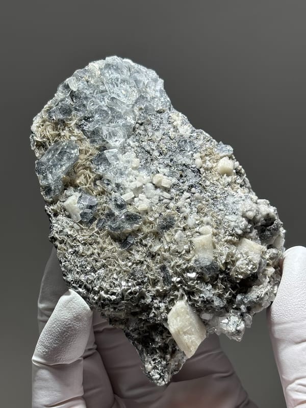 Grey plate with aquamarine, mica and feldspar from Xuebaoding, Sichuan, China, second angle