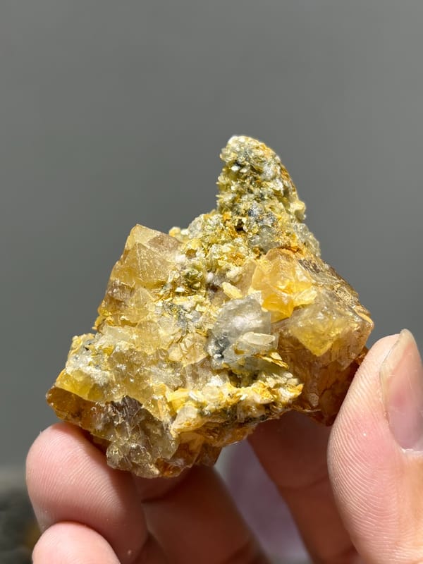 Orange scheelite with aquamarine and mica from Xuebaoding, Sichuan, China, second angle