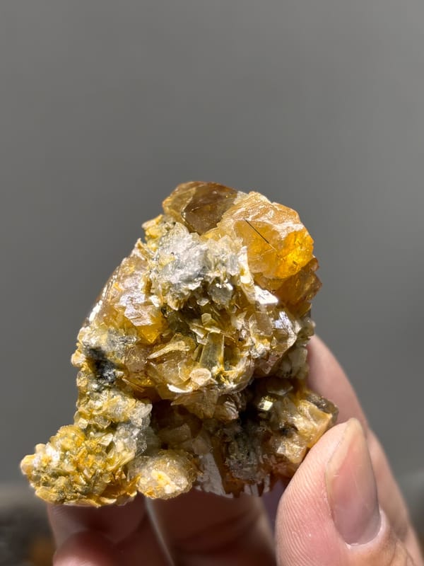 Orange scheelite with aquamarine and mica from Xuebaoding, Sichuan, China, reverse side