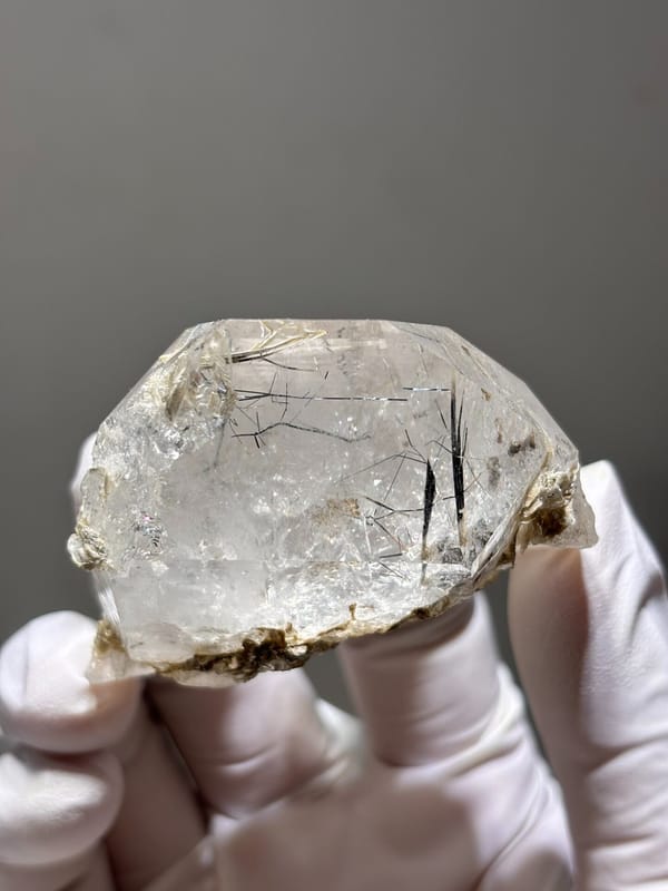 Clear quartz with jamesonite needles on mica from Xuebaoding, Sichuan, China, close-up of the crystal faces