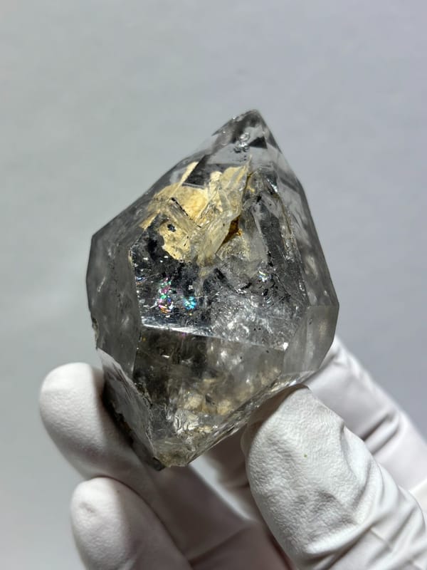 Clay skeletal quartz floater with rainbow flashes from Guizhou, China, top view