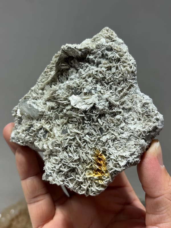 Plate of silvery mica rosettes with aquamarine and scheelite from Xuebaoding, Sichuan, China, second angle